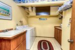 Laundry room with washer, dryer, small ironing board, iron and mud sink. 